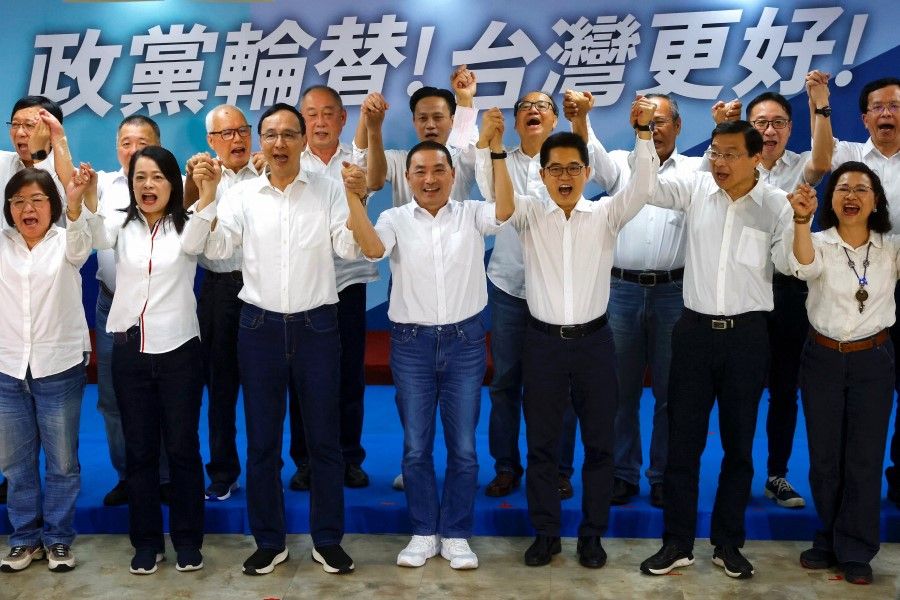 Mayor of New Taipei, Hou Yu-ih, poses for group photos with party members at an event to kick off the presidential campaigns as the candidate for Taiwan's main opposition party Kuomintang (KMT), at their headquarters in Taipei, Taiwan, 20 May 2023. (Ann Wang/Reuters)