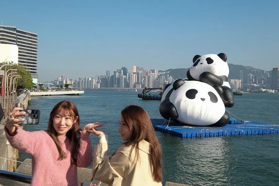 Visitors take photos with panda figures displayed on the water, 11 December 2024. (CNS)