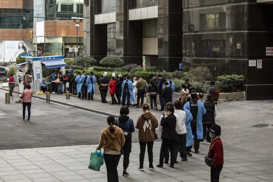 Residents queue at a Covid-19 testing station in Shanghai, China, on 6 November 2022. China will "unswervingly" adhere to its current Covid-19 controls as the country faces increasingly serious outbreaks, health officials said, damping hopes that Beijing will ease its stringent policies that have put cities and factories under prolonged lockdowns. (Qilai Shen/Bloomberg)