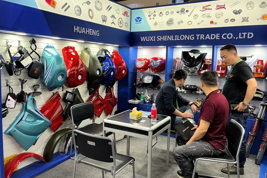 A staff member attends to a visitor at the China Import and Export Fair, also known as Canton Fair, in Guangzhou, Guangdong province, China, 15 April 2023. (Ellen Zhang/Reuters)