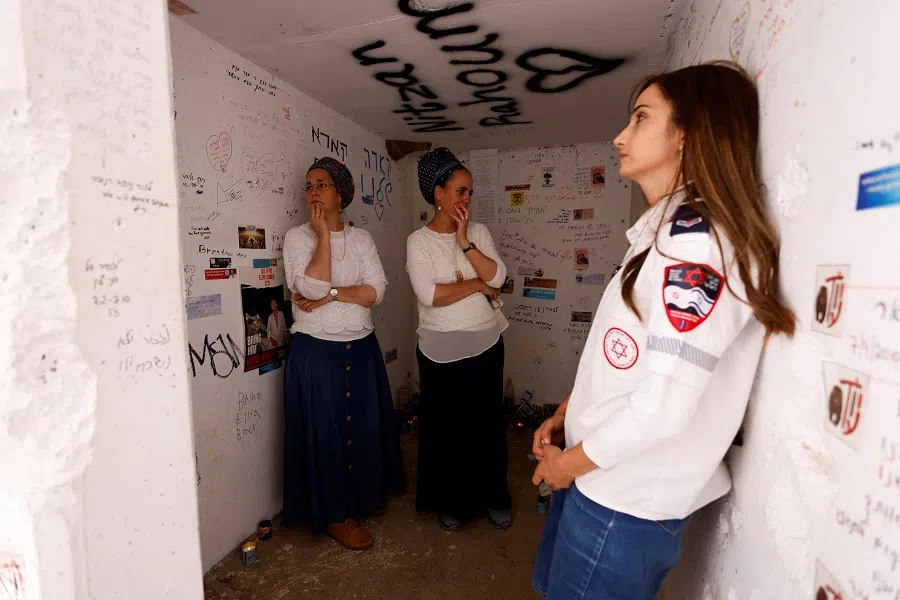 A medic reacts as she stands inside a bomb shelter near the site of the Nova festival, where partygoers were killed and kidnapped during the 7 October attack by Hamas gunmen from Gaza, on Israel’s Memorial Day, when the country commemorates fallen soldiers of Israel’s wars and Israeli victims of hostile attacks, in Reim, Israel, on 13 May 2024. (Amir Cohen/Reuters)
