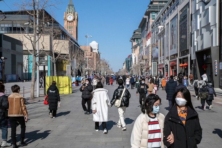 Pedestrians along the Wangfujing shopping area in Beijing, China, on 8 February 2023. (Bloomberg)