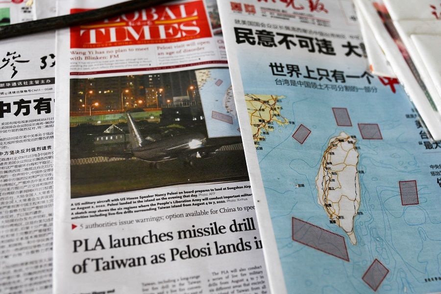 A map showing locations where the Chinese People's Liberation Army (PLA) will conduct military exercises and training activities including live-fire drills is seen on newspaper reports of US House Speaker Nancy Pelosi's visit to Taiwan, at a newsstand in Beijing, China, 3 August 2022. (Tingshu Wang/File Photo/Reuters)