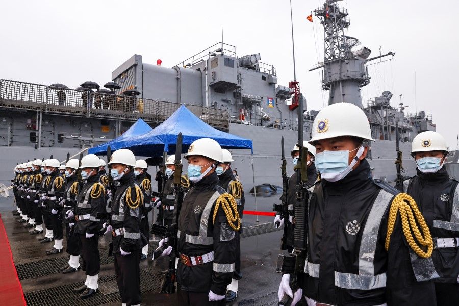 Navy soldiers wear protective masks to prevent the spread of the coronavirus disease (Covid-19) while guarding the ROCS Lan Yang (FFG-935) frigate in Keelung, Taiwan, 8 March 2021. (Ann Wang/Reuters)