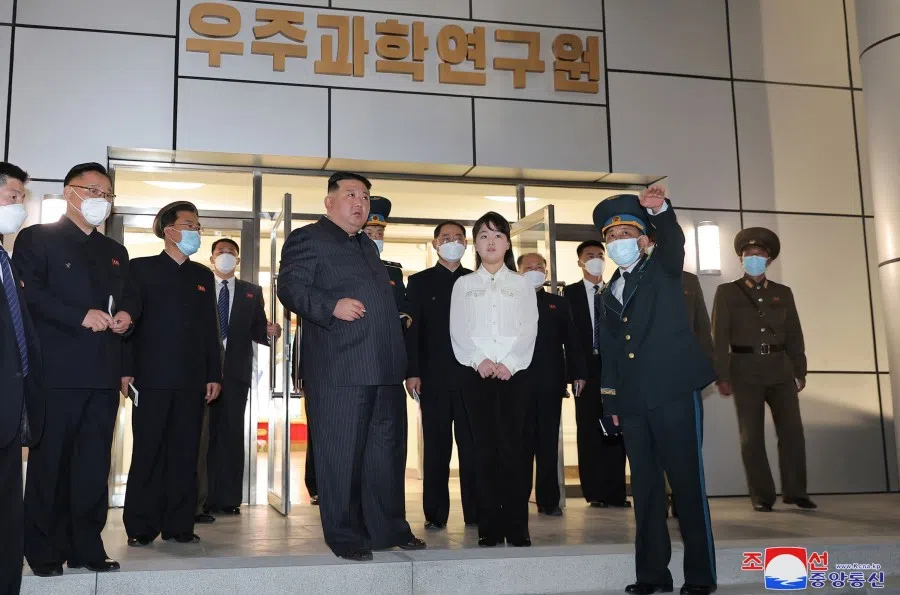 This picture taken on 18 April 2023 and released by North Korea's official Korean Central News Agency (KCNA) on 19 April 2023 shows North Korean leader Kim Jong-un (centre, left) and his daughter, presumed to be named Ju-ae (centre, right), inspecting the National Aerospace Development Administration (NADA) at an undisclosed place in North Korea. (KCNA via KNS/AFP)