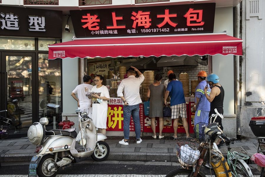 Customers line up to buy dumplings at a store in Shanghai, China, on 30 August 2021. (Qilai Shen/Bloomberg)