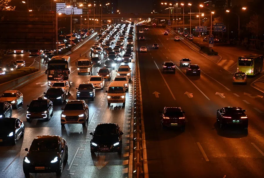 Vehicles drive along a road at the Central Business District (CBD) in Beijing on 15 April 2025. (Adek Berry/AFP)