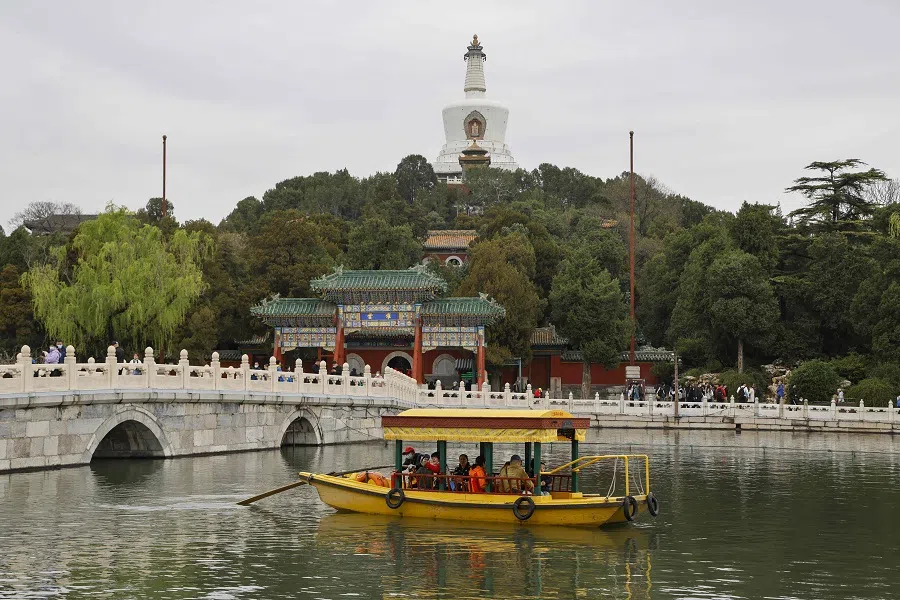 People ride a boat near the Forbidden City in Beijing, China, on 5 April 2023. (Ludovic Marin/AFP)