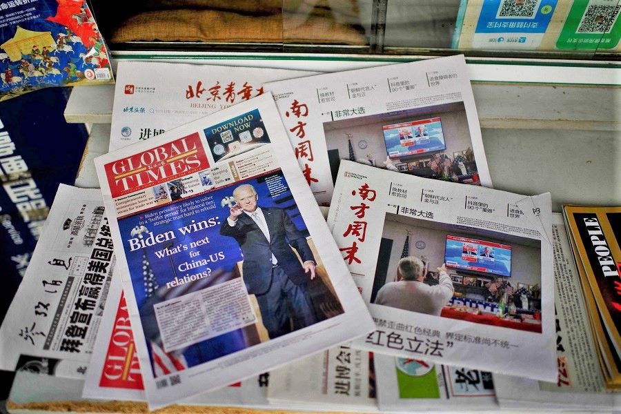 Newspaper front pages lead with the victory of Joe Biden in the US presidential election, at a newsstand in Beijing on 9 November 2020. (Noel Celis/AFP)