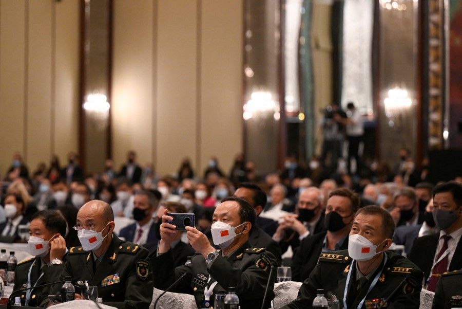 Chinese delegates listen to a virtual special address by Ukraine's President Volodymyr Zelenskyy at the 19th Shangri-La Dialogue in Singapore, 11 June 2022. (Caroline Chia/Reuters)