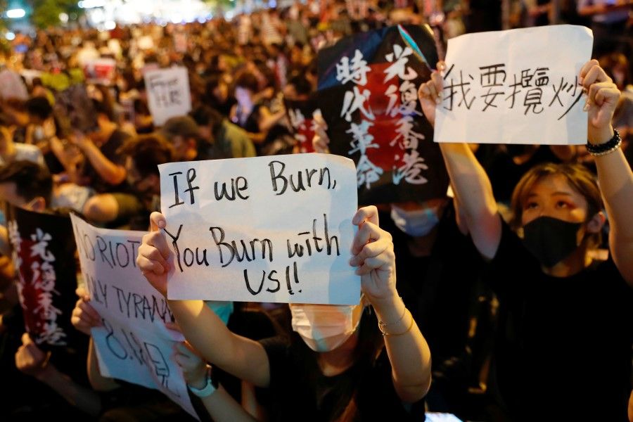 Protesters at a rally, calling on the British and U.S. governments to monitor the implementation of "one country two systems" in Hong Kong. (REUTERS)