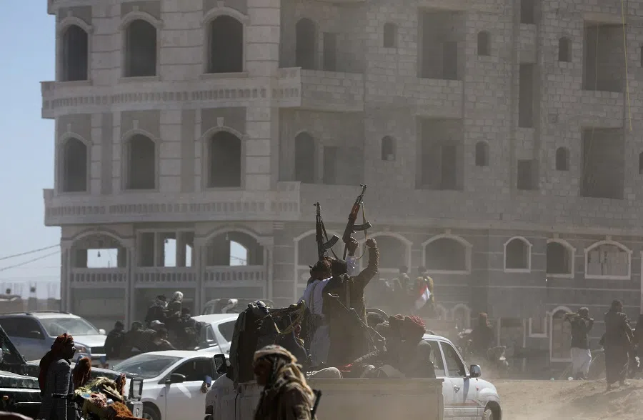 Tribal supporters of the Houthi group hold up their firearms as they leave a protest against recent US-led strikes on Houthi targets, near Sanaa, Yemen, on 14 January 2024. (Khaled Abdullah/Reuters)