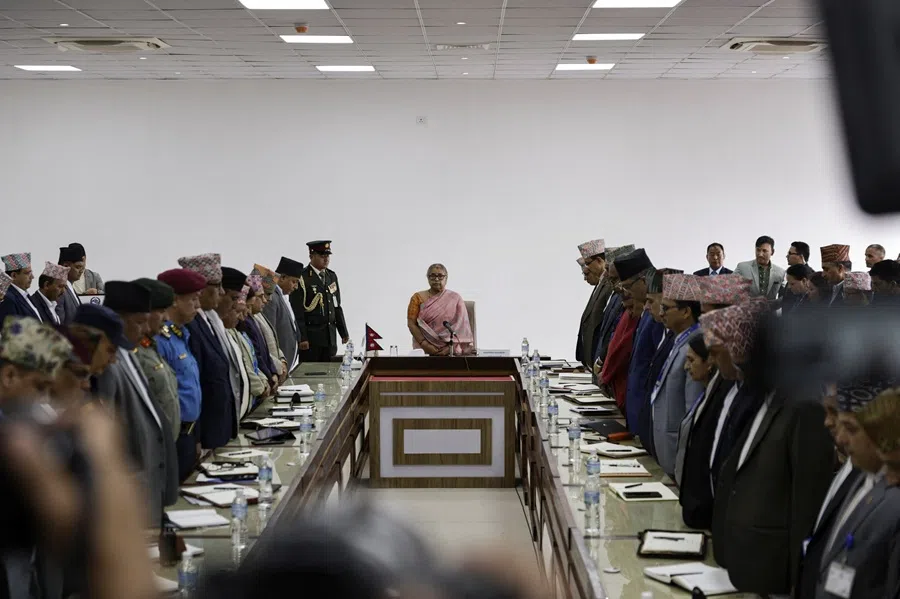 Newly sworn-in interim prime minister of Nepal, Sushila Karki, takes part in a moment of silence in memory of people who died in a protest, during a meeting after assuming the post in her office at Singha Durbar office complex that houses the Prime Minister's office and other ministries, following the protest against anti-corruption triggered by a social media ban in Kathmandu, Nepal, on 14 September 2025. (Navesh Chitrakar/Reuters)