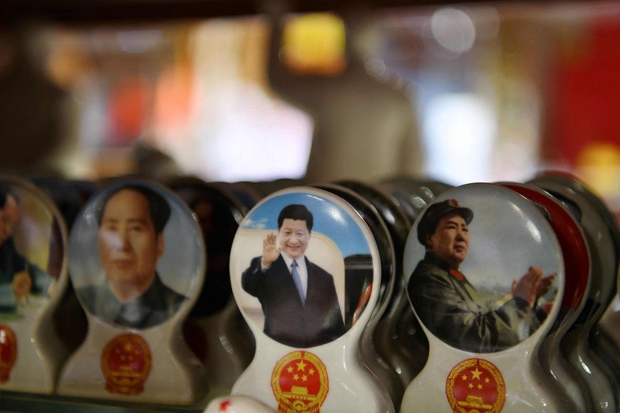 Souvenirs featuring Chinese President Xi Jinping (centre) and late communist leader Mao Zedong (right) are seen at a store in Beijing on 2 March 2021. (Greg Baker/AFP)