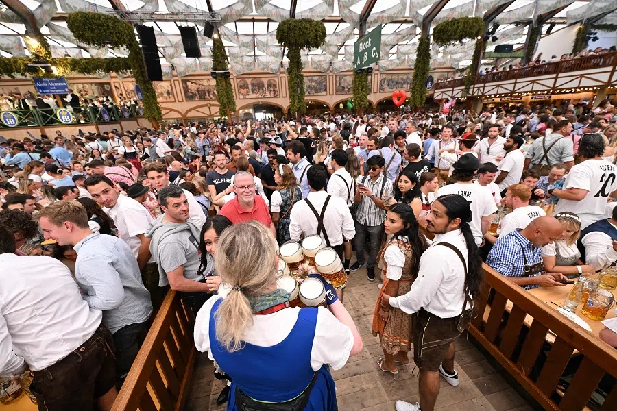 A waiter carries full beer jugs in a festival tent on the opening day of the Oktoberfest beer festival in Munich, southern Germany, on 21 September 2024. (Kirill Kudryavtsev/AFP)