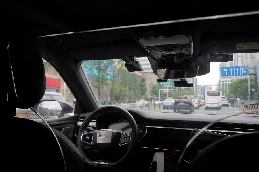 A driverless car by Apollo Go, Baidu’s robotaxi service, drives on a road in Wuhan, Hubei province, China, 19 July 2024. (Sarah Wu/Reuters)