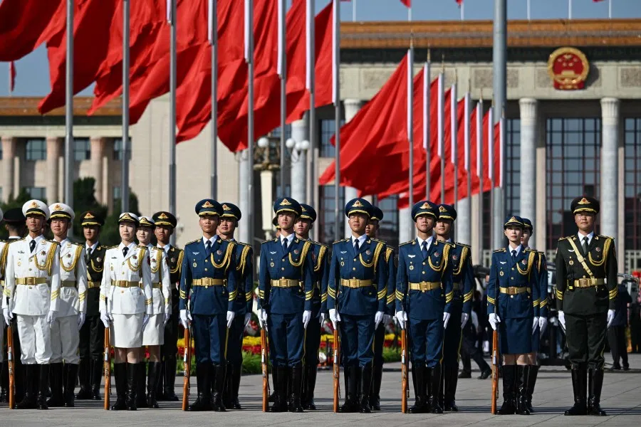 Members of a military honour guard prepare before a wreath laying ceremony to honour deceased national heroes on Martyrs’ Day in Beijing’s Tiananmen Square on 30 September 2025. (Greg Baker/AFP)