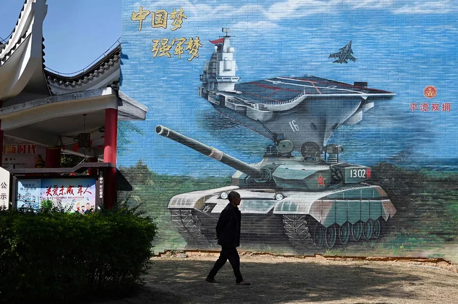 A man walks past a military-themed mural at a public park on Pingtan Island, the closest point in mainland China to Taiwan's main island, in Fujian province, China, on 14 January 2024, the morning after Taiwan's presidential election. (Greg Baker/AFP)