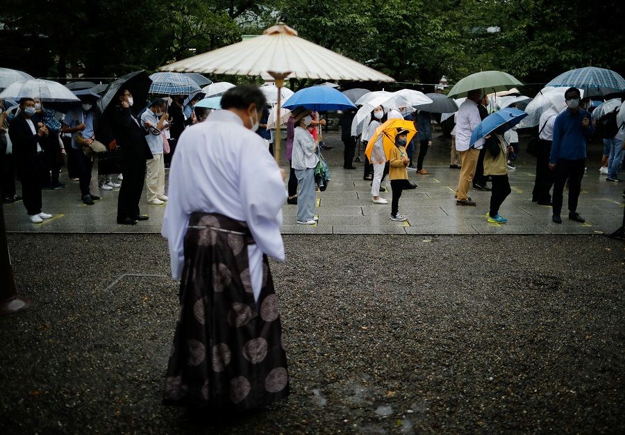 People visit Yasukuni Shrine on the 76th anniversary of Japan's surrender in World War II, in Tokyo, Japan, 15 August 2021. (Issei Kato/Reuters)