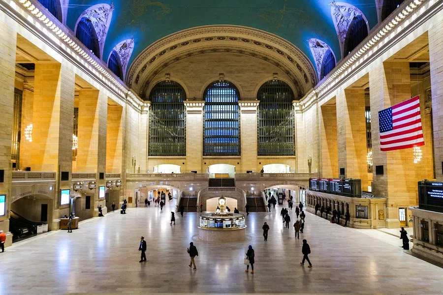 Pedestrians make their way early morning in the hallway of the Grand Central Terminal in New York on 29 February 2024. (Charly Triballeau/AFP)
