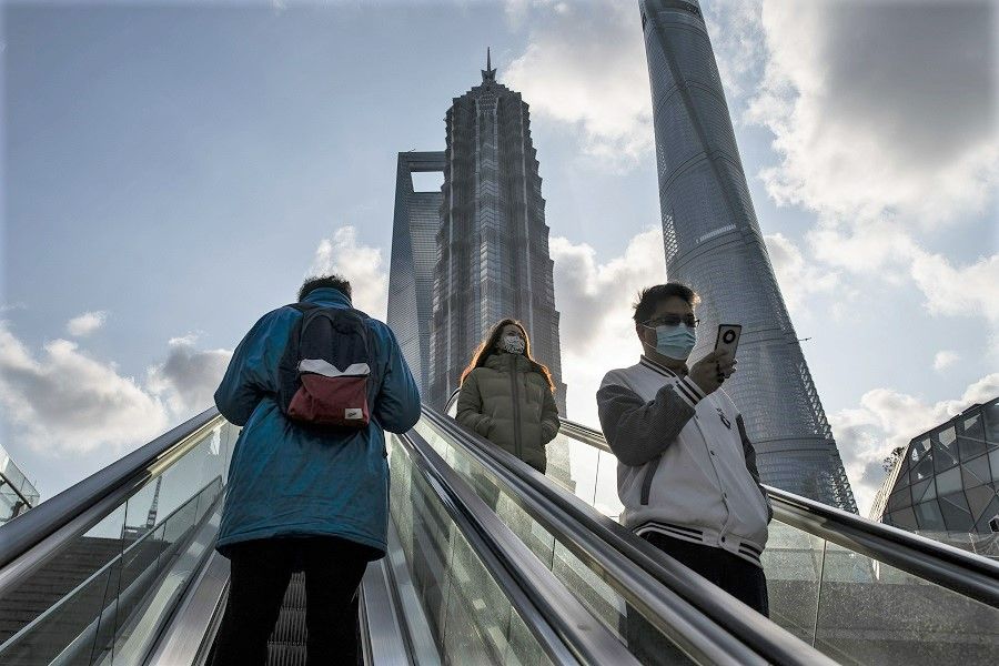 People ride escalators in Pudong's Lujiazui Financial District in Shanghai, China, on 3 January 2023. (Qilai Shen/Bloomberg)