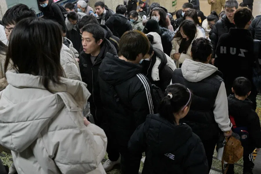 People are seen at a subway station in Beijing on 17 January 2024. (Pedro Pardo/AFP)
