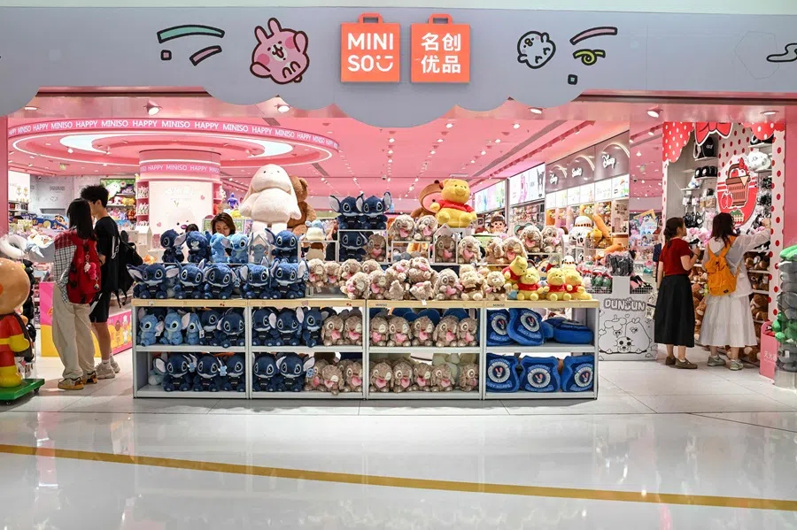 People check items at a Miniso store in a shopping mall in Beijing, China, on 1 July 2025. (Adek Berry/AFP)