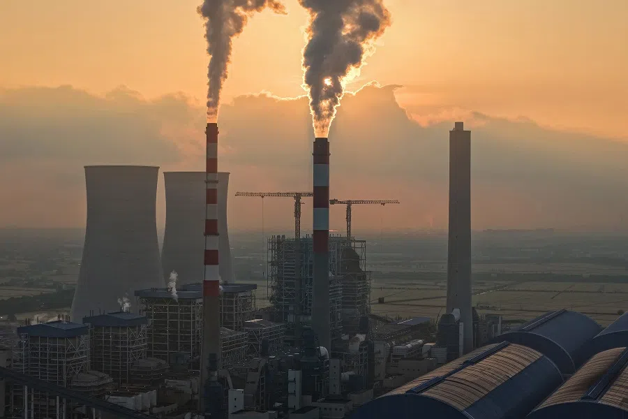 The photo taken on 16 May 2025 shows smoke rising from chimneys at a power plant during sunset in Taicang, in eastern China’s Jiangsu province. (AFP)