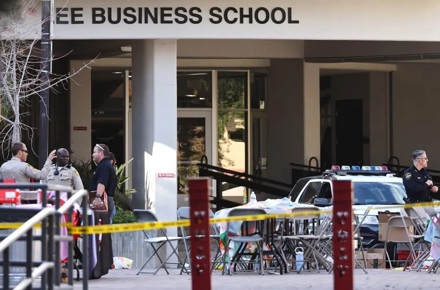 Police officers keep watch near the scene outside Frank and Estella Beam Hall, where the UNLV Lee Business School is located, the morning after a shooting left three dead at the University of Nevada, Las Vegas campus on 7 December 2023 in Las Vegas, Nevada. (Mario Tama/AFP)