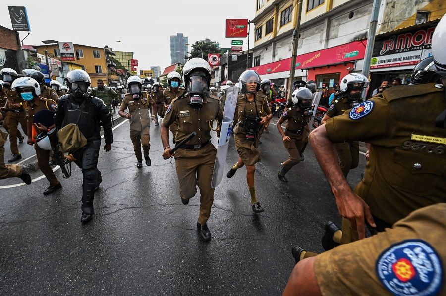 Policemen charge as university students and demonstrators protest against the Sri Lankan government and for the release of student leaders in Colombo, Sri Lanka, on 30 August 2022. (Ishara S. Kodikara/AFP)