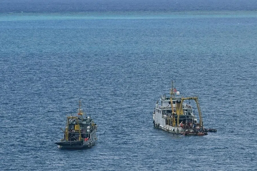 Ships identified by the Philippine Coast Guard as Chinese research vessels are seen at Scarborough Shoal in the disputed South China Sea on 15 June 2026.