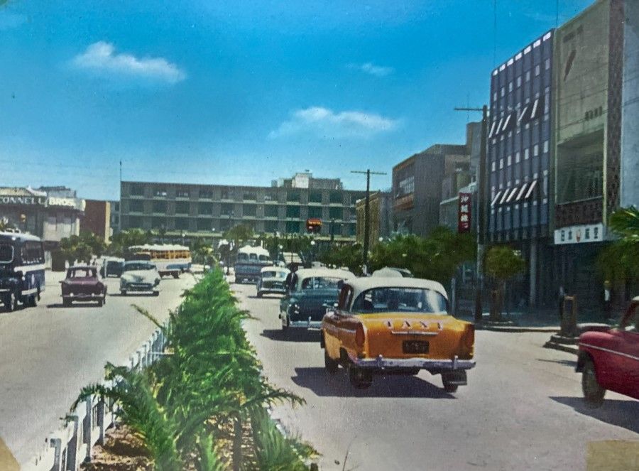 A street in Naha, Okinawa, 1970s. Despite the return of Okinawa's administration to the Japanese government by the US, there were still sentiments against American military bases due to the painful memories of war. The locals also expressed political views different from those of the Tokyo government.