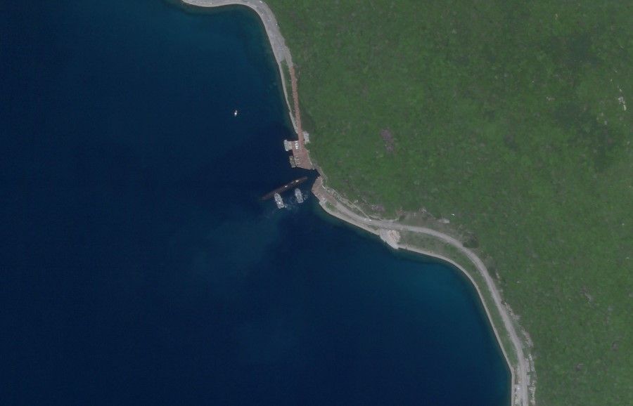 This 18 August 2020 image reportedly shows a Chinese submarine entering an underground base on Hainan Island on the South China Sea. The satellite image appears to show a Type 093 nuclear-powered attack submarine entering a tunnel on Yulin Naval Base. (Planet Labs, Inc./AFP)