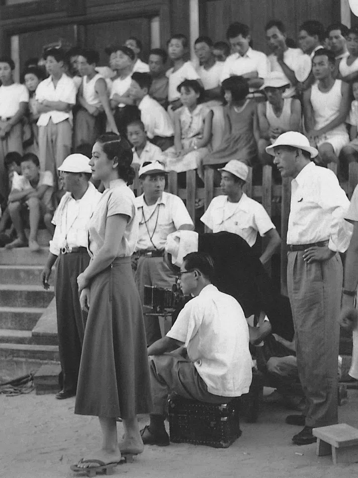 Actress Setsuko Hara (foreground, left) and director Yasujiro Ozu (far right) filming Tokyo Story. (Wikimedia)