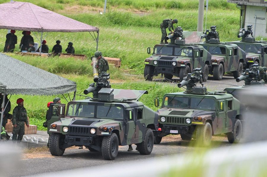 Military vehicles queue to launch US-made TOW A2 missiles during a live-firing exercise in Pingtung county, Taiwan, on 3 July 2023. (Sam Yeh/AFP)