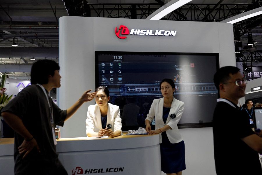 Staff members stand at the booth of Huawei's chip developer Hisilicon, at Security China, an exhibition on public safety and security, in Beijing, China, 7 June 2023. (Florence Lo/Reuters)