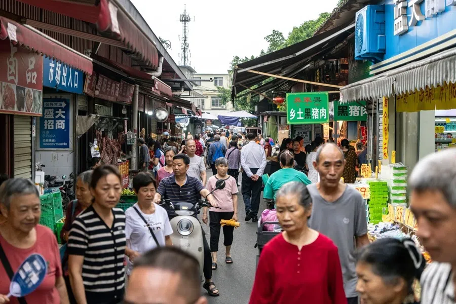 Pedestrians pass food stalls in Chengdu, China, on 17 August 2025. (Bloomberg)