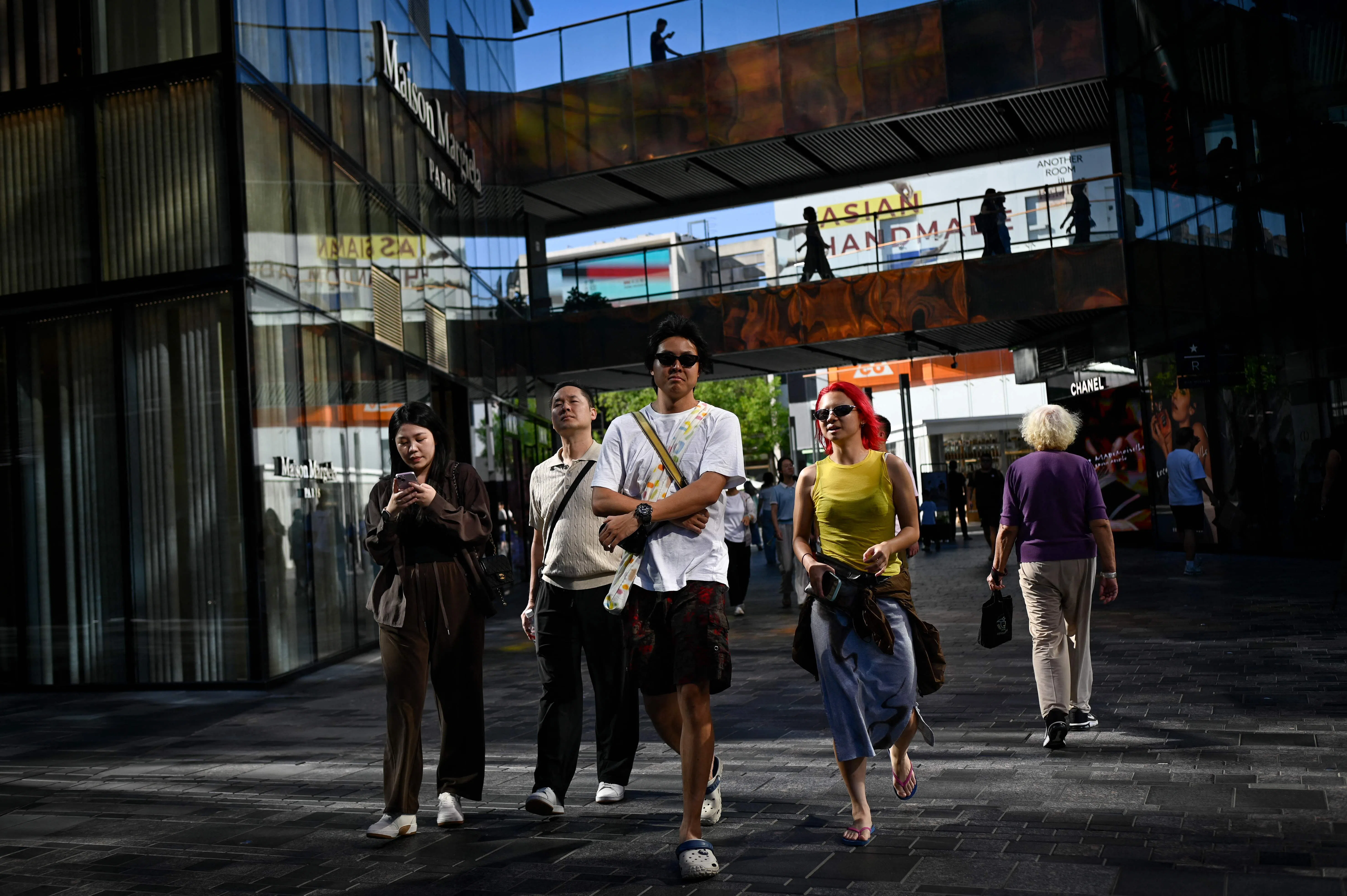 People visit a shopping district in Beijing on 31 August 2026.
