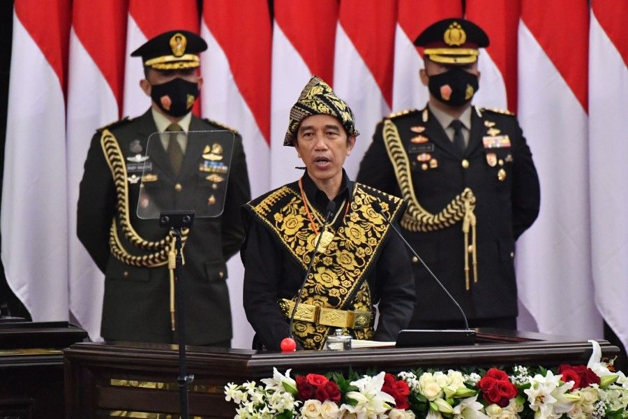 This handout photo taken and released by Indonesia's presidential palace on 14 August 2020 shows Indonesia's President Joko Widodo (C), dressed in a traditional outfit, delivering his state-of-the-nation address at a general assembly at parliament in Jakarta. (Handout/Presidential Palace/AFP)