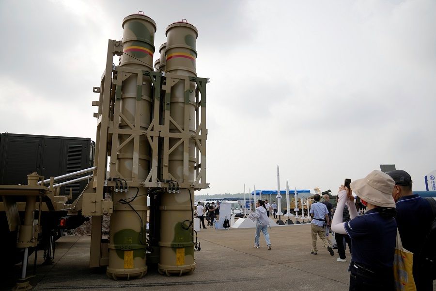 People look at LY-80 surface-to-air missile weapon system displayed at the China International Aviation and Aerospace Exhibition, or Airshow China, in Zhuhai, Guangdong province, China, 29 September 2021. (Aly Song/Reuters)