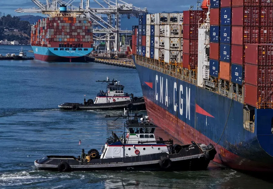 In an aerial view, tugboats assist a container ship as it arrives at the Port of Oakland on 10 October 2025 in Oakland, California. (Justin Sullivan/Getty Images via AFP)