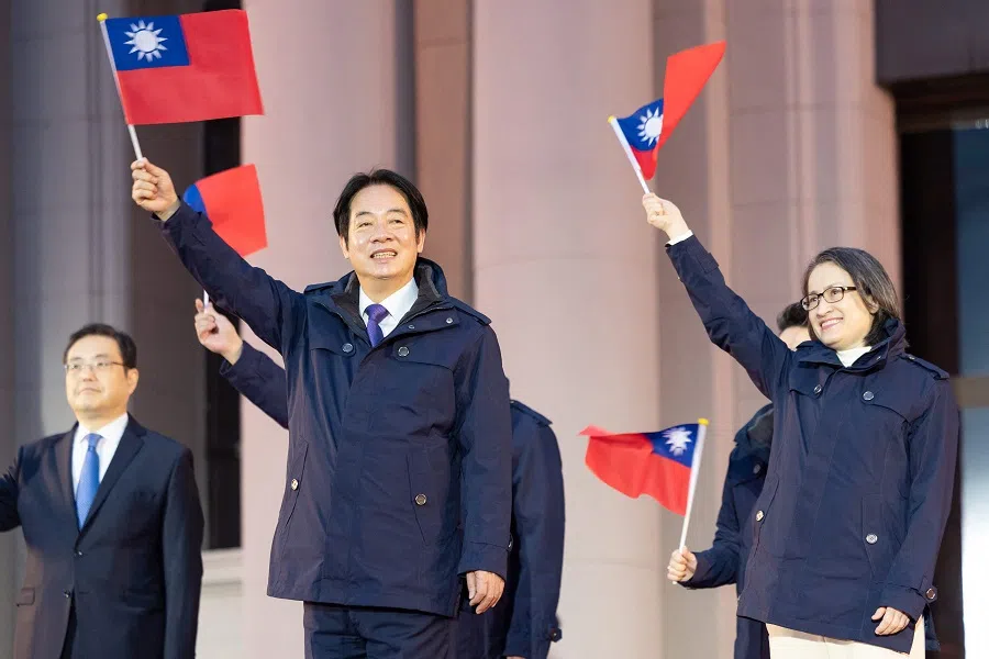 This handout photo taken and released on 1 January 2025 by the Taiwan Presidential Office shows Taiwan’s President Lai Ching-te and Vice-President Hsiao Bi-khim taking part in a flag-raising ceremony at the Presidential office in Taipei, on the first day of the new year. (Taiwan Presidential Office/AFP)