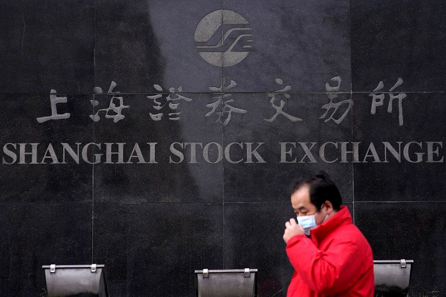 A men wearing a mask walks at the Shanghai Stock Exchange building at the Pudong financial district in Shanghai, China, 3 February 2020. (Aly Song/File Photo/Reuters)