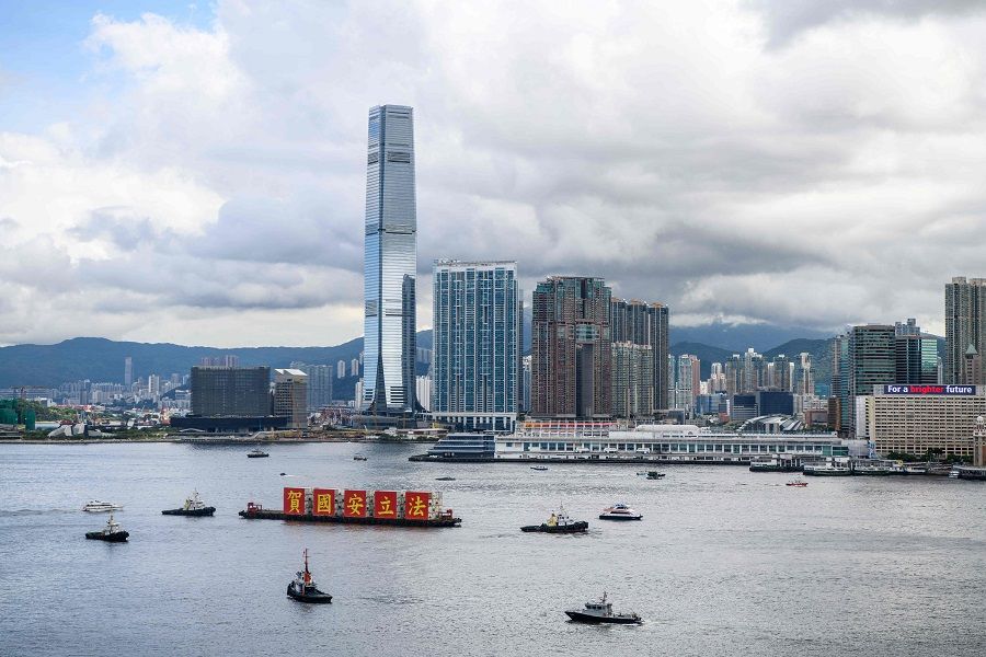 A barge with a banner reading "Celebrate the National Security Law" sails into Victoria Harbour. (Anthony Wallace/AFP)