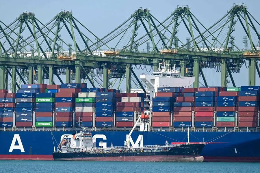 An oil tanker refuels a container vessel docked at Pasir Panjang port terminal in Singapore on 10 March 2026. (Roslan Rahman/AFP)
