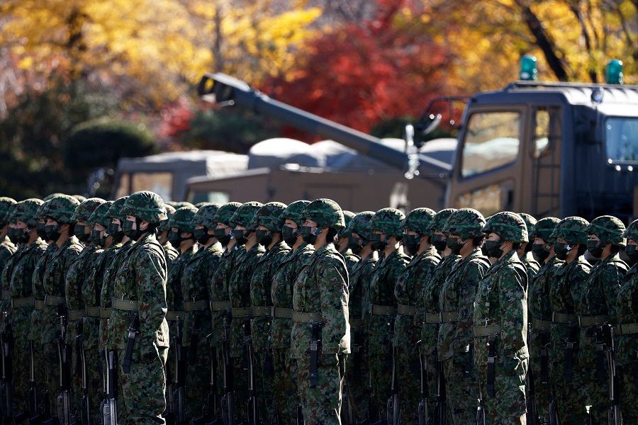 Members of the Japan Ground Self-Defense Force (JGSDF) stand during a review at JGSDF Camp Asaka in Tokyo, Japan, on 27 November 2021. (Kiyoshi Ota/Pool/AFP)