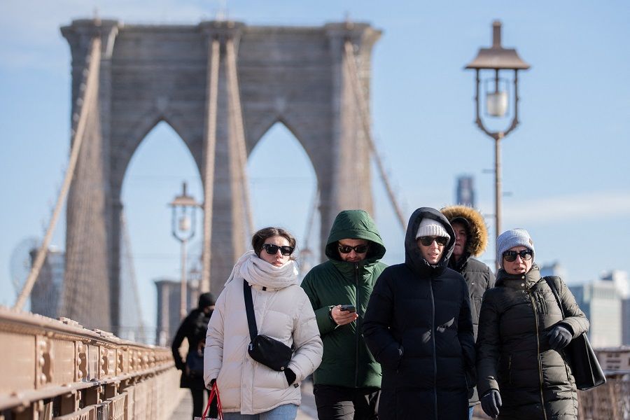 People walk in Manhattan in New York City, New York, US, 4 February 2023. (Jeenah Moon/Reuters)