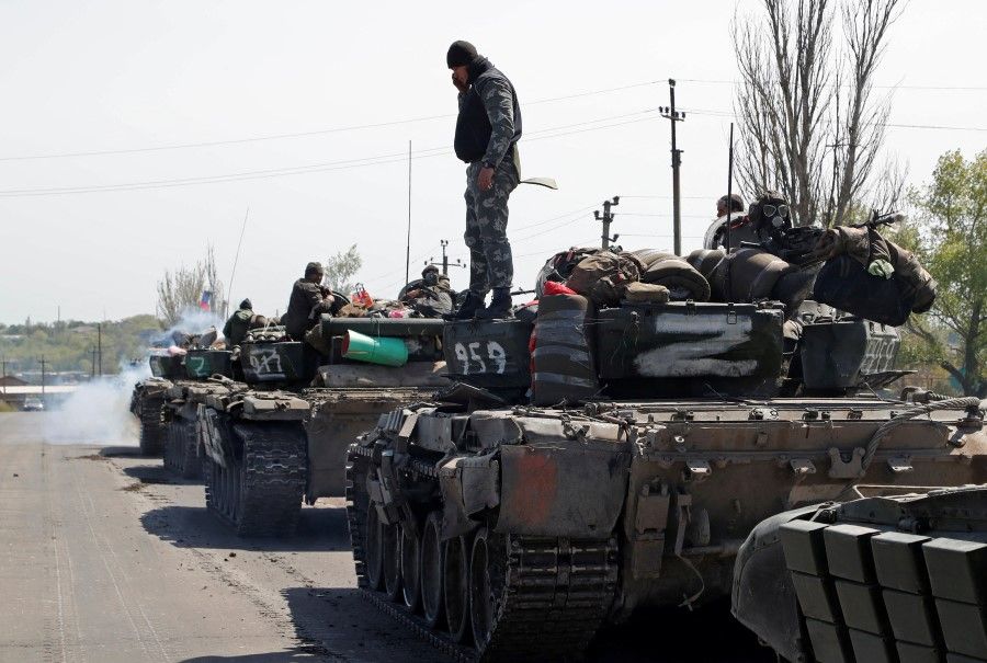 Service members of pro-Russian troops drive armoured vehicles during a Russia-Ukraine conflict near Novoazovsk in the Donetsk Region, Ukraine, 6 May 2022. (Alexander Ermochenko/Reuters)
