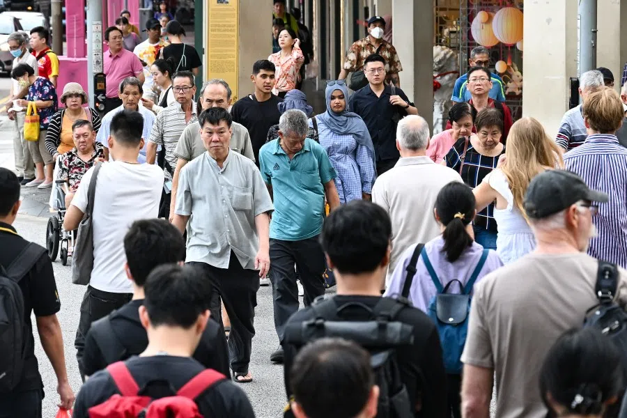 People cross a street in Singapore on 18 September 2025. (SPH Media)