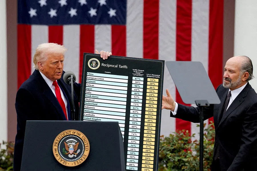 US President Donald Trump holds a chart next to US Secretary of Commerce Howard Lutnick as Trump delivers remarks on tariffs in the Rose Garden at the White House in Washington DC, US, on 2 April 2025. (Carlos Barria/Reuters)